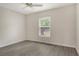 Bedroom with grey flooring, a window with blinds and bright sunlight streaming through at 383 Bobby Jones Rd # 383, Sarasota, FL 34232