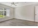 Bright bedroom featuring wood floors, a ceiling fan, and a large window at 383 Bobby Jones Rd # 383, Sarasota, FL 34232