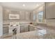 This kitchen features gray cabinets, granite countertops and white appliances at 383 Bobby Jones Rd # 383, Sarasota, FL 34232