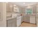 This kitchen features gray cabinets, granite countertops and white appliances at 383 Bobby Jones Rd # 383, Sarasota, FL 34232