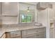 This kitchen features gray cabinets, granite countertops and pass through to the dining area at 383 Bobby Jones Rd # 383, Sarasota, FL 34232