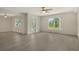 Open-concept living space featuring laminate flooring, neutral paint, and abundant natural light at 383 Bobby Jones Rd # 383, Sarasota, FL 34232