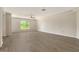 Large living room featuring laminate flooring, natural light, and ceiling fan at 383 Bobby Jones Rd # 383, Sarasota, FL 34232