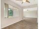 Bright living room features wood floors, a ceiling fan, a large window and access to the lanai at 383 Bobby Jones Rd # 383, Sarasota, FL 34232