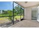 Inviting screened patio area with tile flooring, ceiling fan, and serene outdoor view at 383 Bobby Jones Rd # 383, Sarasota, FL 34232
