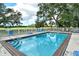 A refreshing pool with tile border is surrounded by lounge chairs and lush green spaces at 383 Bobby Jones Rd # 383, Sarasota, FL 34232