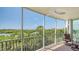 Enjoy the screened balcony with views of the surrounding neighborhood and waterways at 385 N Point Rd # 503, Osprey, FL 34229