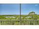 Screened balcony view overlooking lush tropical landscape with waterway and city skyline in the distance at 385 N Point Rd # 503, Osprey, FL 34229