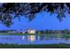 Elegant waterfront home reflected beautifully on the lake at dusk, illuminated by soft, inviting lights at 385 N Point Rd # 503, Osprey, FL 34229