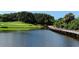 Beautiful pond with green grass and a wooden bridge on a golf course on a nice day at 385 N Point Rd # 503, Osprey, FL 34229