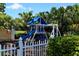 Community playground area with a swing set and slide, fostering outdoor fun and recreation at 385 N Point Rd # 503, Osprey, FL 34229