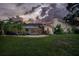 The backyard at dusk features a screened pool, lush landscaping, and an inviting outdoor space at 3936 Spyglass Hill Rd, Sarasota, FL 34238