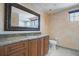 Bathroom features a granite countertop vanity, with a large mirror and coordinated tile flooring at 3936 Spyglass Hill Rd, Sarasota, FL 34238
