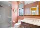 Cozy bathroom featuring a glass-enclosed shower, a window with blinds, and a classic vanity with sink at 3936 Spyglass Hill Rd, Sarasota, FL 34238