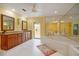 Luxurious bathroom featuring a soaking tub, double vanities, and bright, airy design at 3936 Spyglass Hill Rd, Sarasota, FL 34238