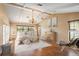 Inviting bedroom with vaulted ceilings, wood floors, a chandelier, and comfortable furnishings at 3936 Spyglass Hill Rd, Sarasota, FL 34238