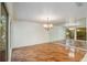 Spacious dining area featuring hardwood floors, a decorative chandelier, and mirrored wall at 3936 Spyglass Hill Rd, Sarasota, FL 34238