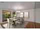 Elegant dining room featuring a decorative chandelier, a large window with a view, and hardwood floors at 3936 Spyglass Hill Rd, Sarasota, FL 34238