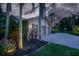 Lovely home with a three-car garage, a paver driveway, and lush tropical landscaping at 3936 Spyglass Hill Rd, Sarasota, FL 34238