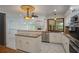 Bright open kitchen featuring stainless steel appliances, granite countertops, and white cabinetry at 3936 Spyglass Hill Rd, Sarasota, FL 34238