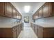A well-lit laundry room with abundant cabinetry, a sink, and a washing machine for convenience at 3936 Spyglass Hill Rd, Sarasota, FL 34238