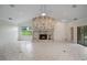 Bright living room featuring a stone fireplace, tiled floors, and sliding glass doors to a pool area at 3936 Spyglass Hill Rd, Sarasota, FL 34238