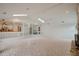 Bright living room featuring tiled floors, a partial-height divider, and access to the kitchen at 3936 Spyglass Hill Rd, Sarasota, FL 34238