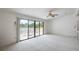 Bright living room with large sliding glass doors leading to a patio overlooking a picturesque lake at 3936 Spyglass Hill Rd, Sarasota, FL 34238
