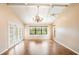 Bright living room with vaulted ceilings, wood floors, a ceiling fan, and access to the outdoors at 3936 Spyglass Hill Rd, Sarasota, FL 34238