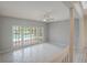 Bright living room with white tile floors, white walls, and views of the outdoor pool through french doors at 3936 Spyglass Hill Rd, Sarasota, FL 34238