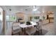 Open-concept dining and kitchen space featuring large table, granite countertops, and stone fireplace at 3936 Spyglass Hill Rd, Sarasota, FL 34238