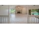 Inviting open-concept living space with a stone fireplace, white tile flooring, and natural light at 3936 Spyglass Hill Rd, Sarasota, FL 34238