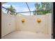 Outdoor patio with a private walled area and decorative lion head accents at 3936 Spyglass Hill Rd, Sarasota, FL 34238