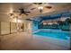 Screened-in pool area features a pool, spa, and outdoor living space with views of the golf course at 3936 Spyglass Hill Rd, Sarasota, FL 34238