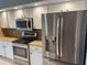 Modern kitchen featuring stainless steel appliances, granite countertops, and white cabinetry at 40 Mariner Ln, Rotonda West, FL 33947