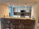 Stylish kitchen with granite counters, breakfast bar seating, pendant lights and stainless steel appliances at 40 Mariner Ln, Rotonda West, FL 33947