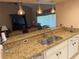 Kitchen featuring a stainless steel sink, granite countertops, and pendant lighting at 40 Mariner Ln, Rotonda West, FL 33947