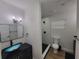 Modern bathroom with a glass bowl sink, walk-in shower, and black fixtures at 4210 Baird St, Sarasota, FL 34232
