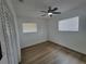 Inviting bedroom with neutral walls, wood floors, and ample natural light from two windows at 4210 Baird St, Sarasota, FL 34232
