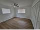 Cozy bedroom featuring wood-look floors, ceiling fan, and generous closet space at 4210 Baird St, Sarasota, FL 34232