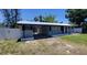 Charming single story home with a metal roof, carport and white fencing at 4210 Baird St, Sarasota, FL 34232