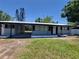 Beautiful single story home featuring a metal roof, front carport and clean landscaping at 4210 Baird St, Sarasota, FL 34232