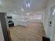 Open floor plan with a kitchen featuring white cabinets and stainless steel appliances at 4210 Baird St, Sarasota, FL 34232