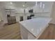 Modern kitchen features stainless steel appliances, white cabinets, and ample counter space with an island at 4210 Baird St, Sarasota, FL 34232