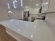 Bright kitchen features stainless steel appliances and a large quartz countertop at 4210 Baird St, Sarasota, FL 34232