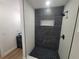 Walk-in shower with black fixtures and decorative tile at 4210 Baird St, Sarasota, FL 34232