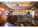Spacious bar area featuring dark wood accents, bar stools, and custom decor at 4225 Ulman Ave, North Port, FL 34286