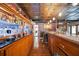 Unique bar area with a long counter, glass shelves, and hardwood floors at 4225 Ulman Ave, North Port, FL 34286