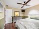 Bright bedroom with a ceiling fan, sleek dresser, and a window for natural light at 4225 Ulman Ave, North Port, FL 34286