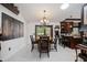 Dining room featuring a chandelier, table, and access to the kitchen bar area at 4225 Ulman Ave, North Port, FL 34286
